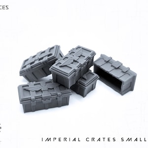 May include: A set of five gray, miniature Imperial crates. The crates have detailed designs, including embossed emblems and latch details. The text "5X PIECES" is at the top, and "IMPERIAL CRATES SMALL SET" is at the bottom.