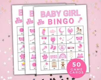 May include: Three baby girl bingo game cards with pink text and illustrations. The cards feature images of baby-related items like a bottle, pacifier, and teddy bear. The cards are labeled "Baby Girl Bingo" and "50 Game Cards".