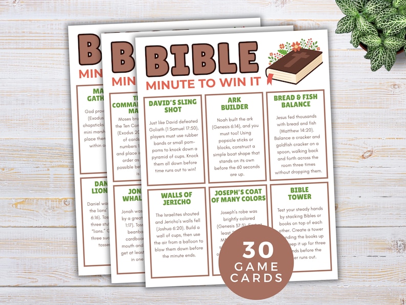 以下が含まれることがあります： さまざまな課題が記載された「Bible Minute to Win It」というタイトルの3枚のゲームカード。カードは、ゲームの説明と本のグラフィックを備えた茶色と白の配色が特徴です。「30ゲームカード」と書かれた円形のグラフィック。