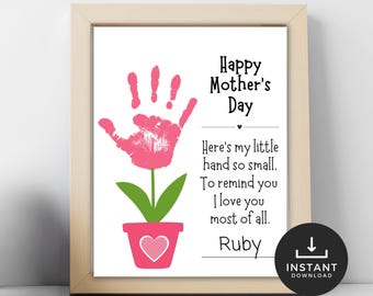 May include: A printable Mother's Day card featuring a pink handprint shaped like a flower with green leaves and a pink heart in the pot. The card reads "Happy Mother's Day" and "Here's my little hand so small. To remind you I love you most of all. Ruby".