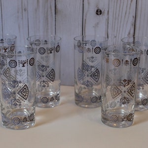 May include: Set of six clear glass tumblers with a geometric pattern in black and silver. The pattern features circles, squares, and triangles.