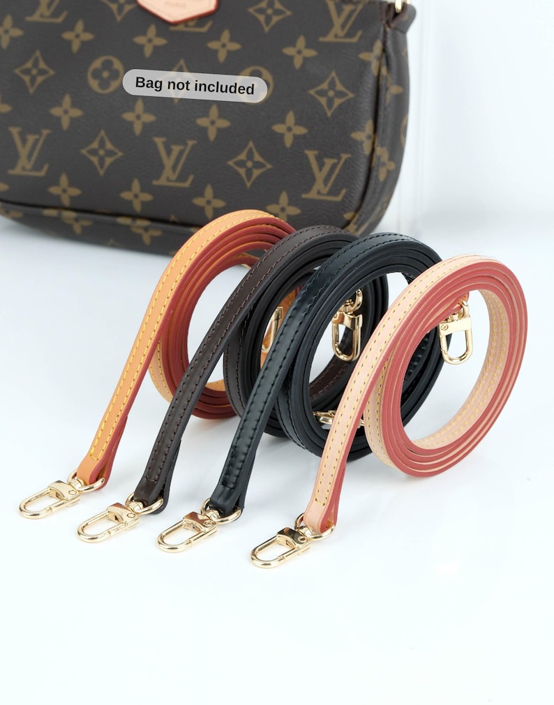 May include: Four leather purse straps in tan, brown, black, and pink with gold-colored clasps. The straps are coiled and displayed against a white background. A brown purse with a logo is visible in the background. Text on the image reads "Bag not included."