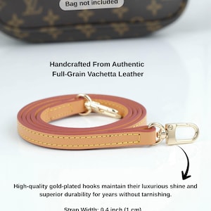 May include: A tan and pink leather purse strap with gold-plated hooks. The strap is 0.4 inches (1 cm) wide and made from full-grain Vachetta leather. The image includes the text: "Bag not included."