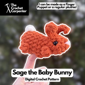 May include: A crocheted orange bunny plushie with black eyes and a white tail. The text on the image says "Sage the Baby Bunny" and "Digital Crochet Pattern". The image also states "I can be made as a Finger Puppet or a regular plushie!"