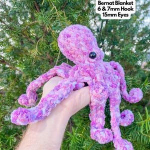 May include: A crocheted purple and white octopus with black eyes. The octopus is made with Bernat Blanket yarn and a 6 & 7 mm hook. The eyes are 15 mm.