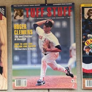 May include: Three vintage baseball magazines with the title "Tuff Stuff." The covers feature baseball players and the text "The Mick," "Roger Clemens," and "Babe's." The magazines are displayed on a light brown surface.