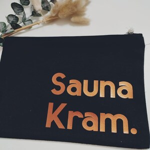May include: Black canvas zippered pouch with the words "Sauna Kram" in copper foil lettering.
