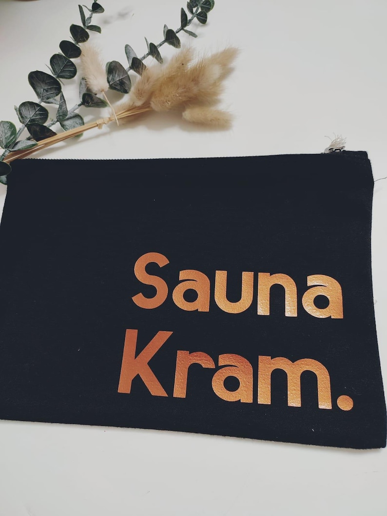 May include: Black canvas zippered pouch with the words "Sauna Kram" in copper foil lettering.