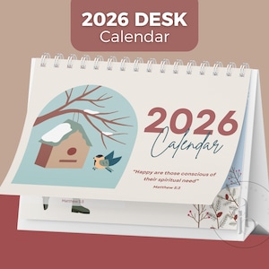 May include: A 2026 desk calendar with a spiral binding. The calendar features a winter scene with a birdhouse, a bird, and the text "2026 Calendar." The quote "Happy are those conscious of their spiritual need" is also included.