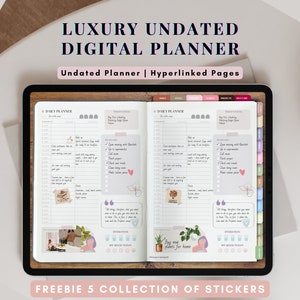 以下が含まれることがあります： ピンクと白のカラーテーマでタブレットの画面に表示されているデジタルプランナーアプリ。プランナーは日付が設定されておらず、ハイパーリンクされたページが含まれています。アプリには、スケジュール、ToDoリスト、メモのセクションがあるデイリープランナーが含まれています。アプリには、画像に表示されているステッカーのセクションも含まれています。画像の下部に「FREEBIE 5 COLLECTION OF STICKERS」というテキストが表示されています。