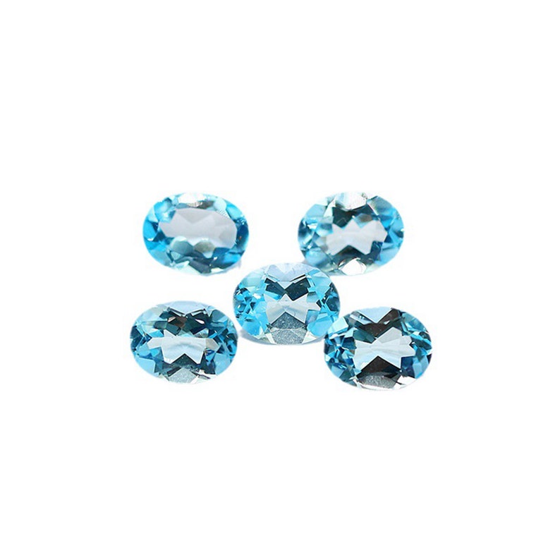 May include: Five oval-shaped, faceted, light blue gemstones on a white background.