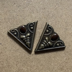 May include: Two gold-tone metal triangle-shaped corner protectors with a brown stone accent in the center of each.