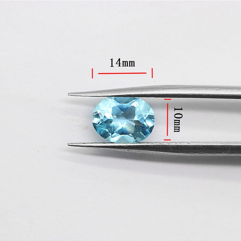 May include: A light blue oval gemstone measuring 14mm in length and 10mm in width.