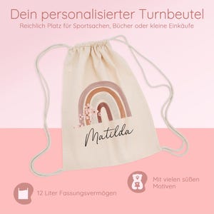 May include: A beige drawstring backpack with a rainbow design and the name "Matilda" in cursive. The bag has a capacity of 12 liters and features the text "Dein personalisierter Turnbeutel" and "Mit vielen s&uuml;&szlig;en Motiven".