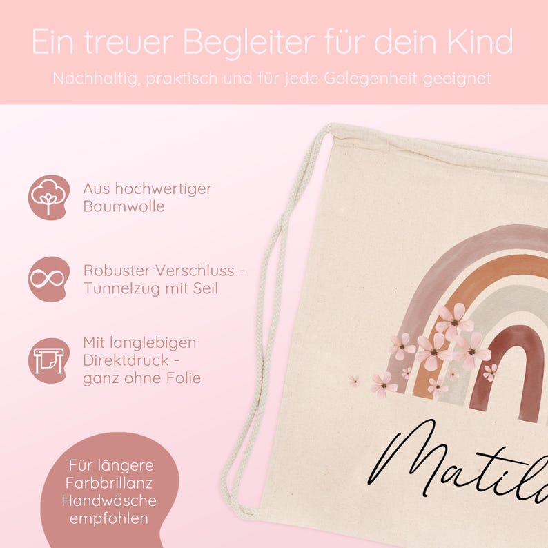 May include: A beige drawstring backpack with a watercolor rainbow design and the name "Matilda" in cursive. The bag features a sturdy drawstring closure and is made of high-quality cotton. The text "Ein treuer Begleiter f&uuml;r dein Kind" is at the top.