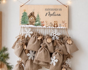 May include: A wooden advent calendar sign with the text "ADVENTSKALENDER VON Melina" featuring a printed winter forest scene with a cabin, pine trees, and woodland animals. Twenty-four small burlap drawstring bags hang from the sign with white wooden snowflake ornaments and round wooden numbered tags.