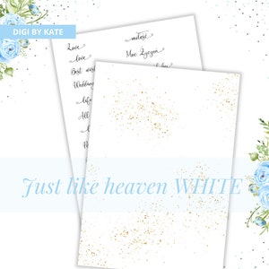 May include: A white card with gold glitter scattered on it. The text "Just like heaven WHITE" is printed on the card. The card is surrounded by a blue floral border.