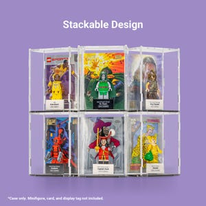 May include: Clear, stackable display cases showcasing various minifigures and cards. The cases feature figures like Kobe Bryant, Dr. Doom, and Captain Hook. The text "Stackable Design" is visible at the top. The cases are displayed against a purple background.