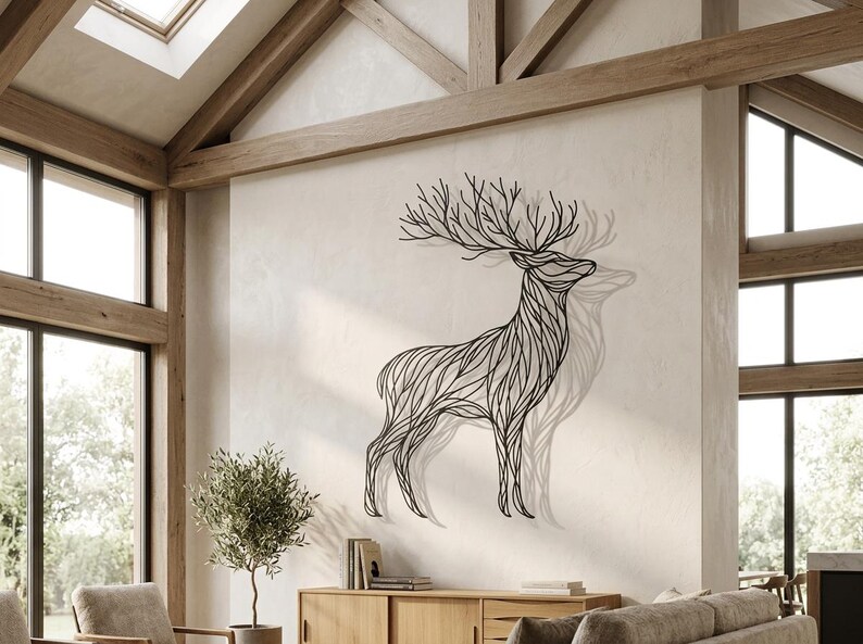 May include: A black metal deer wall art sculpture. The deer is depicted in a linear style with intricate details, mounted on a neutral-colored wall. The sculpture casts a shadow, enhancing the three-dimensional effect. The artwork adds a touch of nature-inspired decor.