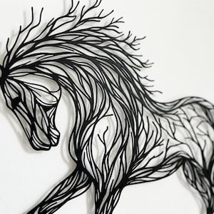 May include: Black metal wall art of a horse in motion. The horse's shape is formed by a network of lines, similar to tree branches. The artwork is mounted on a white wall, creating a strong contrast. A decorative piece.