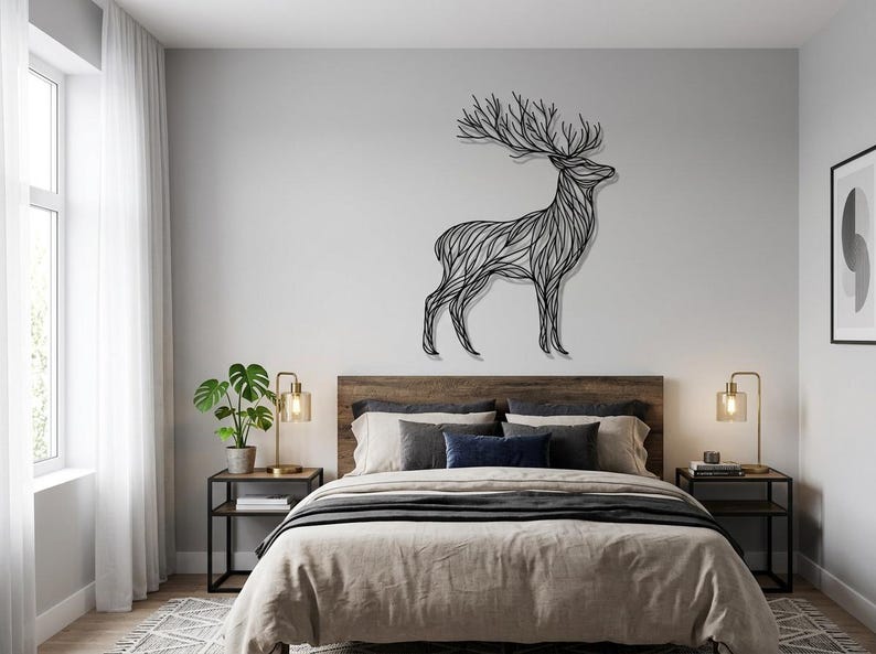 May include: A black metal deer wall art decorates a bedroom wall above a bed with a wooden headboard. The deer is stylized with an intricate, flowing design. The room has neutral tones with a window and side tables with lamps.