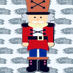 May include: A red and blue nutcracker cookie cutter with a white face, black eyes, and a brown hat. The cutter has a black belt and a pair of black boots with pink accents.