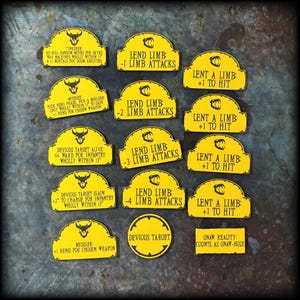 May include: A collection of yellow game tokens with black text and graphics. The tokens have various phrases like "Lend Limb" and "Devious Target". The tokens are for a tabletop game.
