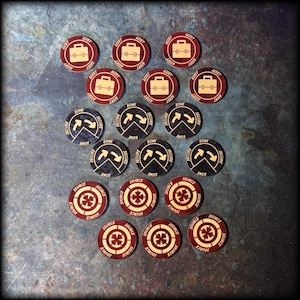 May include: A selection of wooden game tokens. The tokens are circular with a dark red border and a light tan centre. Some feature a briefcase icon, others have arrows, and some a cross-like design. Text includes "ASSET", "ZONE", "SECURE", and "SOURCE".