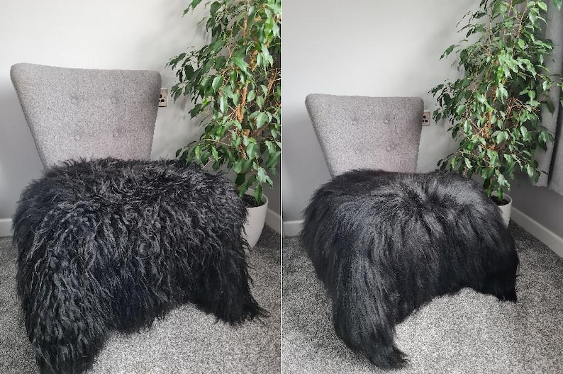 May include: A gray upholstered chair with a high back and two tufted buttons, draped with a long-haired black sheepskin rug. The chair features a tapered backrest and a seat covered by the thick, textured, dark fur that hangs over the edges.