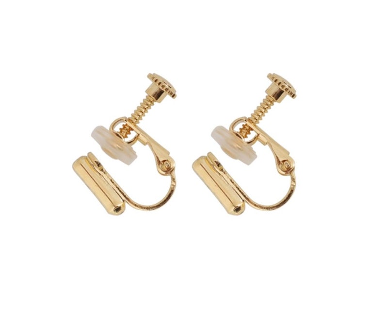 May include: A pair of gold-tone clip-on earrings with a screw-on back.