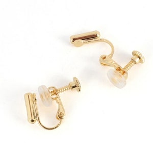 May include: Two gold-tone clip-on earring backs. Each back has a screw-on post and a clear plastic pad.
