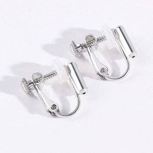 May include: A pair of silver clip-on earrings with a screw-on back.