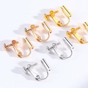 May include: Six pairs of gold and silver ear clips. The clips are designed to hold earrings in place for people with sensitive ears.