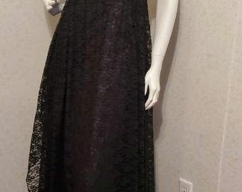 May include: A white and black formal dress with a lace skirt and puffed sleeves. The dress has a fitted bodice and a flowing skirt.
