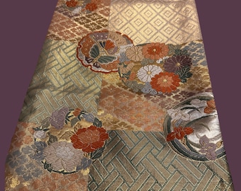 May include: A traditional Japanese fabric panel with a gold and green geometric pattern. The fabric features a variety of floral motifs, including butterflies and chrysanthemums.