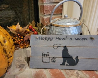 Cute trick-or-treating rabbit with howling dog laser engraved on wooden sign. Reads &#39;Hoppy Howl-o-ween&#39;.