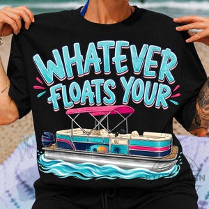 May include: Black t-shirt with the phrase "WHATEVER FLOATS YOUR" in turquoise and pink. The shirt features a graphic of a pontoon boat with a pink canopy, palm trees, and a sunset design.
