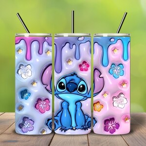 May include: Three insulated tumblers with a Stitch design. Each tumbler features a colorful, dripped paint effect in pink, blue, and purple, adorned with floral and star accents. The tumblers have black straws.