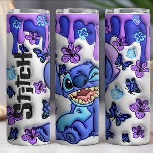May include: A stainless steel tumbler featuring a cartoon character, Stitch, with a purple and blue design. The tumbler has a white background with purple drips, butterflies, and flowers. The word "Stitch" is written vertically.