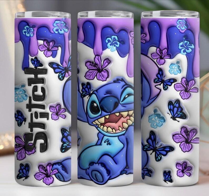 May include: A stainless steel tumbler featuring a cartoon character, Stitch, with a purple and blue design. The tumbler has a white background with purple drips, butterflies, and flowers. The word "Stitch" is written vertically.