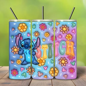 May include: A set of three insulated tumblers featuring a cartoon character, Stitch, surrounded by flowers and Mickey Mouse icons. The word "STITCH" is displayed in colorful bubble letters. Each tumbler has a black straw.