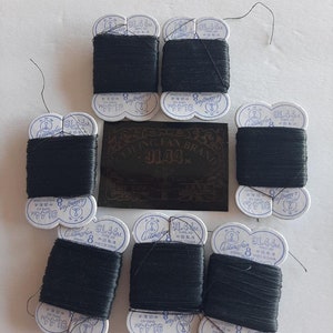 May include: A close-up of ten spools of black thread, each wrapped in white paper with the brand name "Ceilingfan" and the text "91.44M THREAD MADE IN CHINA".