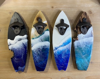 May include: Four surfboard-shaped bottle openers with a wave design. Each opener is made of wood and resin and features a black metal bottle opener.