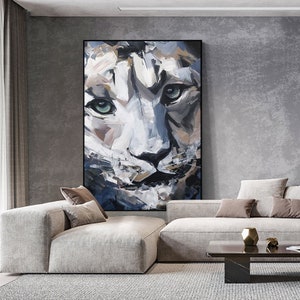 May include: A close-up painting of a snow leopard's face. The painting is done in a loose, expressive style with bold brushstrokes. The snow leopard's fur is white with black markings, and its eyes are a piercing blue.