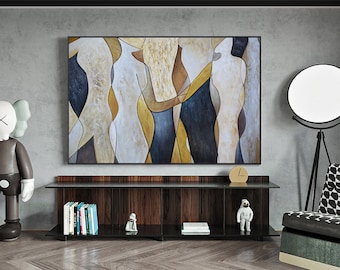 May include: Abstract painting of three figures in shades of brown, yellow, and blue. The painting is framed and hanging on a gray wall above a dark wood shelf.