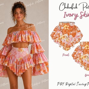 Op de afbeelding: Een tweedelige set bestaande uit een off-shoulder top met ruches en lange gelaagde mouwen en een rok met hoge taille, beide in een oranje en roze bloemenprint. De afbeelding bevat technische schetsen met het label Front en Back.