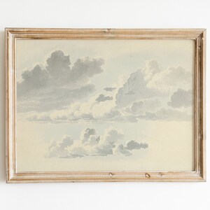May include: A framed watercolor painting of a cloudy sky. The clouds are painted in shades of gray and white, and the background is a light blue.