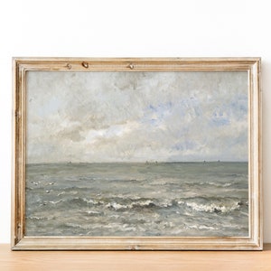 May include: A framed painting of a seascape with a cloudy sky and choppy waves. The painting is in a light wood frame.