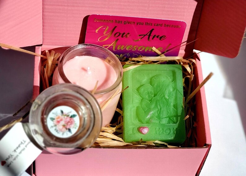 May include: A pink gift box with a pink candle, a green soap bar with a heart design, and a card that says "You Are Awesome!"