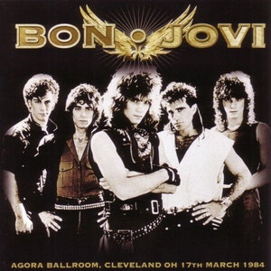 May include: A black and white photo of the rock band Bon Jovi. The band members are standing in a row, with the lead singer in the center. The photo was taken at the Agora Ballroom in Cleveland, Ohio on March 17, 1984. The band's name is written in gold letters at the top of the photo.